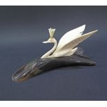 A carved ivory crowned swan on a carved water buffalo plinth, weight 112g, L18cm. The swans crown