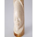 An African elephant ivory tusk carved with a head circa early 20th century. L33cm, weight 725g. This