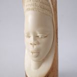 An African elephant ivory tusk carved with a head circa early 20th century. L40cm, weight 1033g.