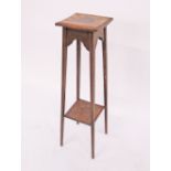 An Arts & Crafts oak two tier jardinière stand with square oak top and arched frieze. H96cm,