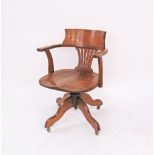 An English Victorian oak revolving desk chair on four splayed legs and castors. H80cm, W58cm,