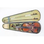 A 19th century violin with carved scroll end, cased in a wooden case with two bows. The first bow (