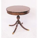 A Regency style mahogany drum library table, with a veneered top, one frieze drawer, on a turned