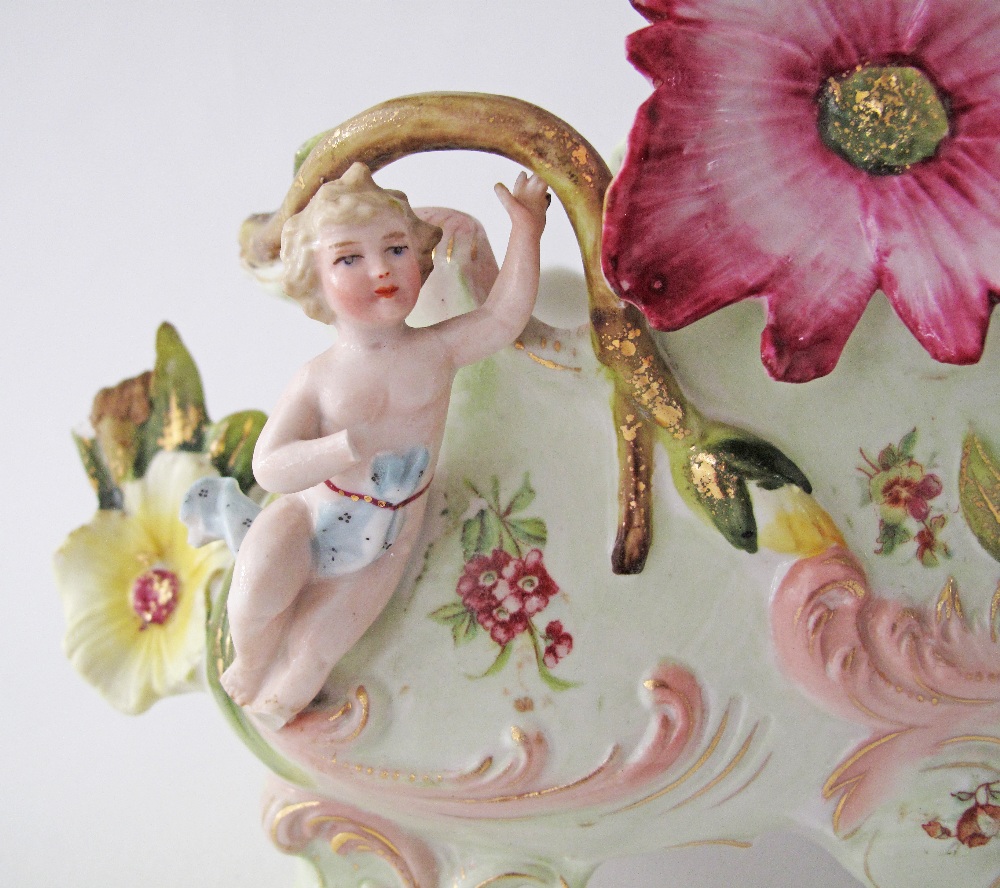 An unmarked porcelain boat probably French Samson, decorated with flowers and cherubs in relief, - Image 3 of 4