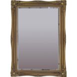 A gesso and gilt framed beveled oblong mirror. 20th century. 106X75cm.