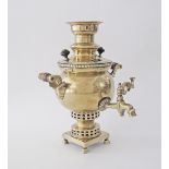 An antique Russian Brass Samovar, Batashev rubbed stamp to base, two mounts with turned wooden