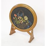 An oval gilt wood framed embroidered fire screen. H67cm, W65cm.