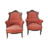 A c19th century carved walnut pair of armchairs, upholstered in pink velvet. W76cm, D76cm, H97cm (