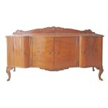 A Cypriot Chippendale style dresser, carved and veneered walnut, on cabriole legs, four shaped doors