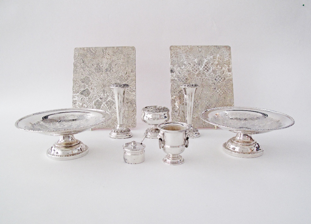 A collection of silver plated dinner table accessories comprising a pair of hot plate coasters, a