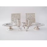 A collection of silver plated dinner table accessories comprising a pair of hot plate coasters, a