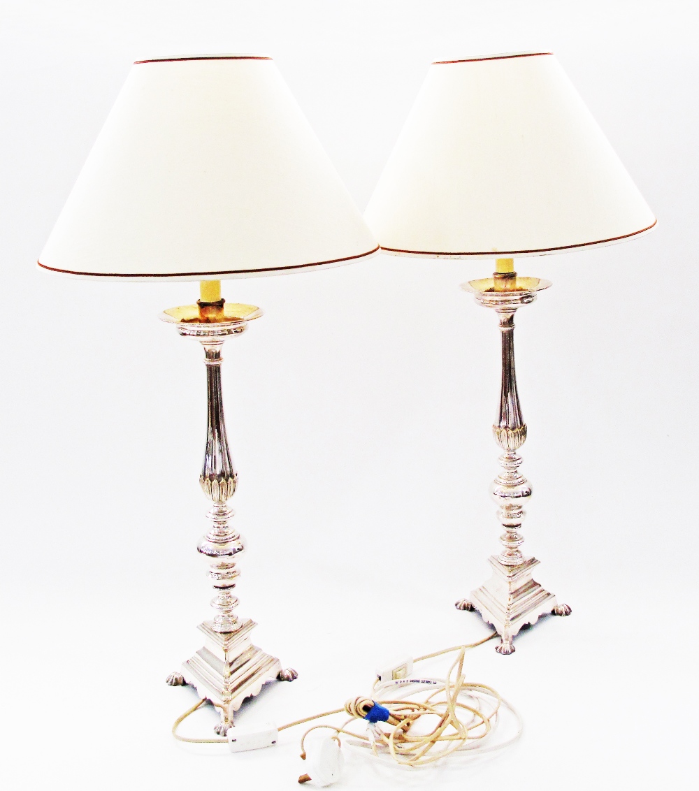 A pair of silver plated candle sticks converted to table lamps, the candlesticks