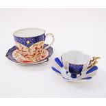 An 18th century porcelain tea cup and saucer and a small 18th century coffee cup and saucer