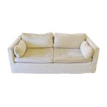A modern two seater sofa upholstered in beige fabric