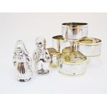 A pair of silver plated salt & pepper cellars in the form of Dutch children