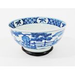 A Chinese blue and white bowl bearing Ming Dynasty, Xuande markings on wooden base