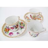 Three Dresden hand decorated porcelain coffee cups with two saucers, c19th century.
