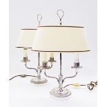 A pair of silver plated table lamps with twin heads and oval shades