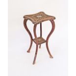 A carved walnut side table inlaid with silver probably Persian.