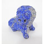 A Chinese carved lapis lazuli figure of a lion.