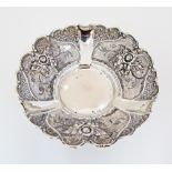 A Sterling silver bowl repousse with roses and flowers, on three small feet.