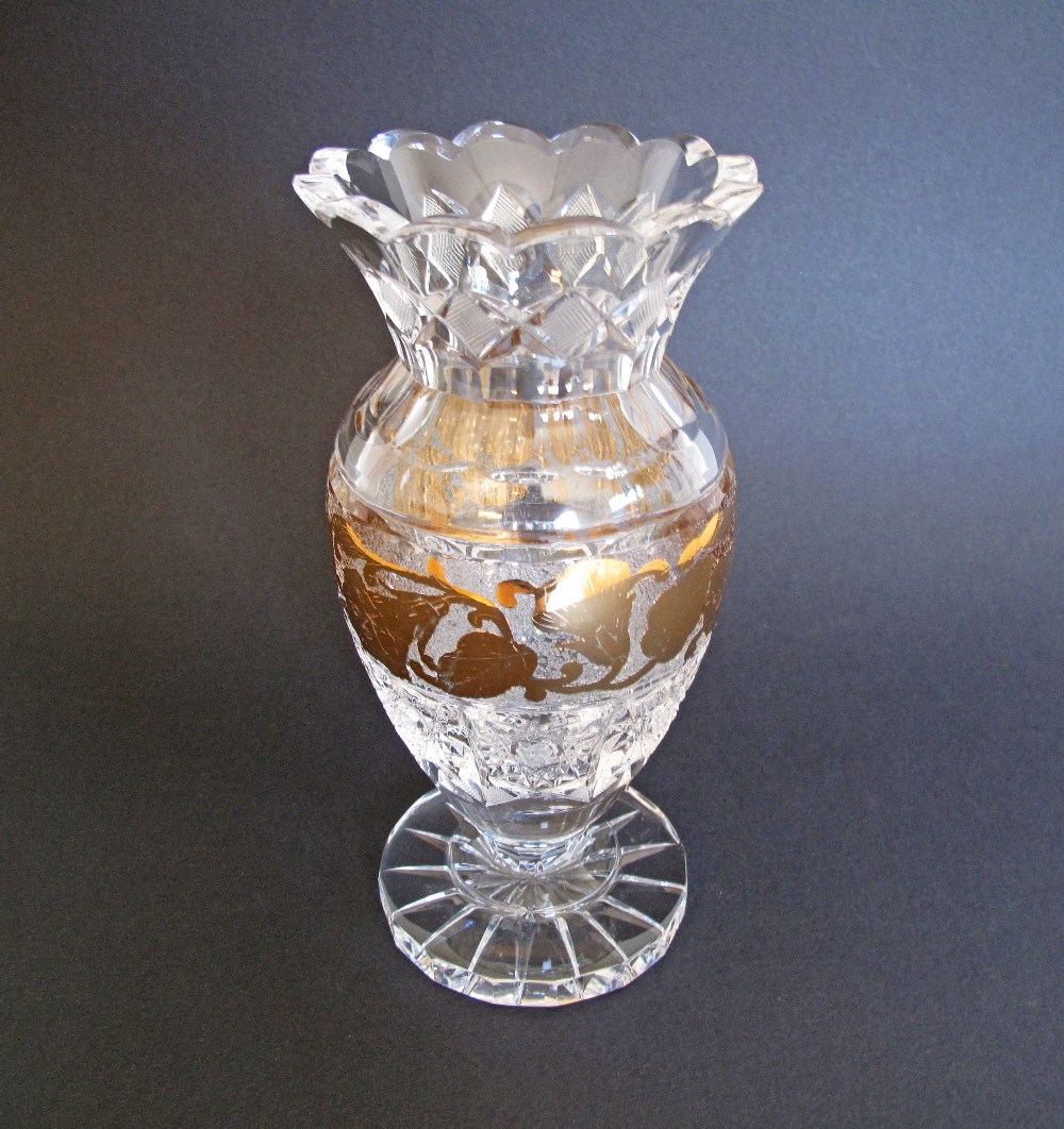 A Bohemian lead crystal footed vase with gold band. H21cm