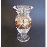 A Bohemian lead crystal footed vase with gold band. H21cm