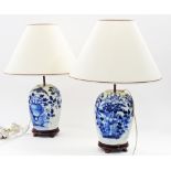 A pair of Chinese porcelain blue and white vases converted to table lamps on wooden bases.