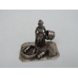 An Early 20th Century Dutch Silver Miniature of a Farmers Wife Feeding the Pigs, Her Dog Close