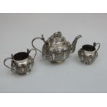 A Three Piece Indian Silver Bachelors Tea Set with Lobed and Profusely Decorated Bodies, Cobra