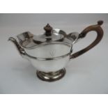 A Late Victorian Silver Teapot with a Central Girdle, Raised Petal Rim, Petal Mount to the Spout