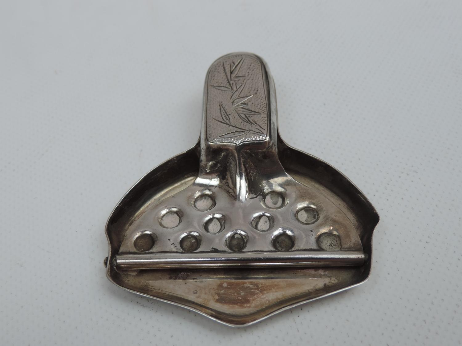 An Antique Chinese Lemon Squeezer with Foliate Motif to the Handle - Hallmarked 'Tacking Sterling