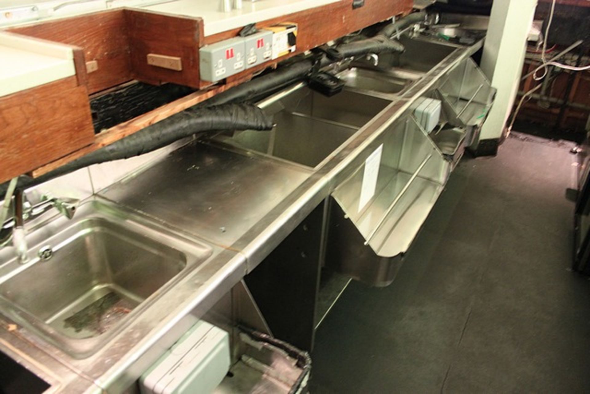 Stainless steel back bar countering comprising of 3 xx sinks, ice dumps, speed rails and shelving