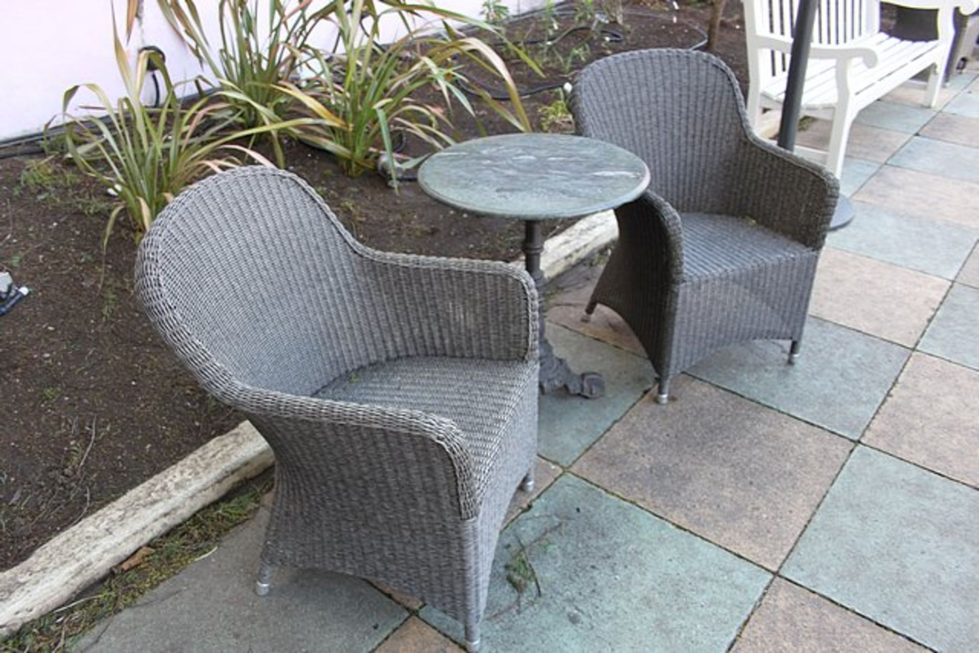 Monte Carlo rattan armchairs complete with a marble top solid cast ornate base table 600mm