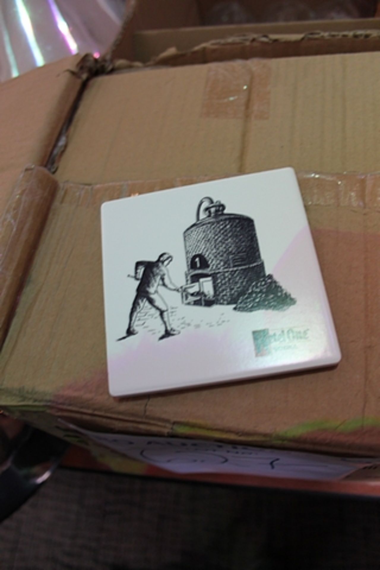 A box of decorative ceramic coasters