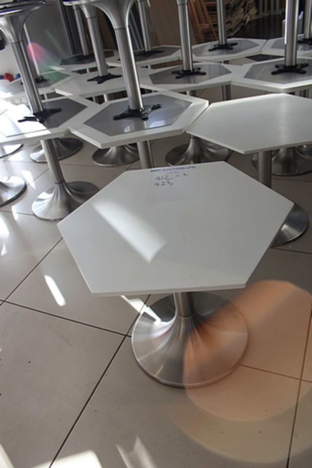 2 x Hexagonal marble top table white mounted on stainless steel trumpet base 560mm x 510mm tall