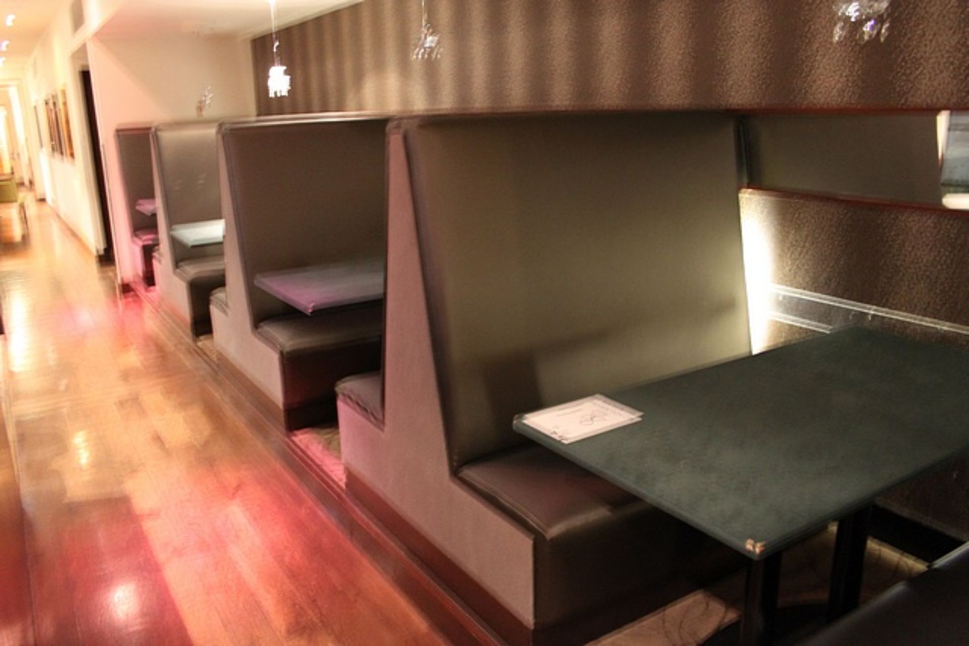 Banquette seating comprising four booths seating 16 persons upholstered in grey linen and PU silk