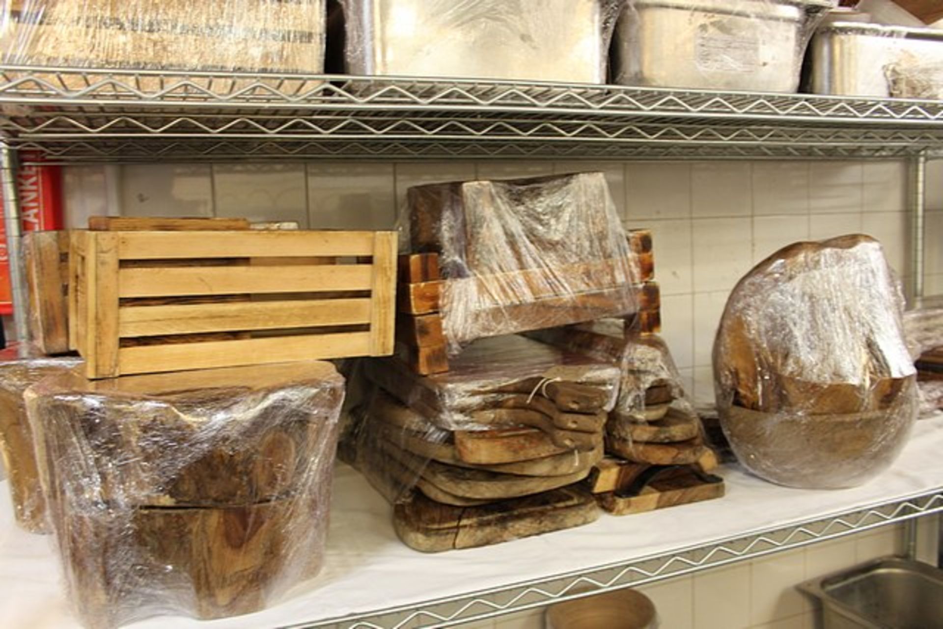 A large quantity of wooden platters and display tableware