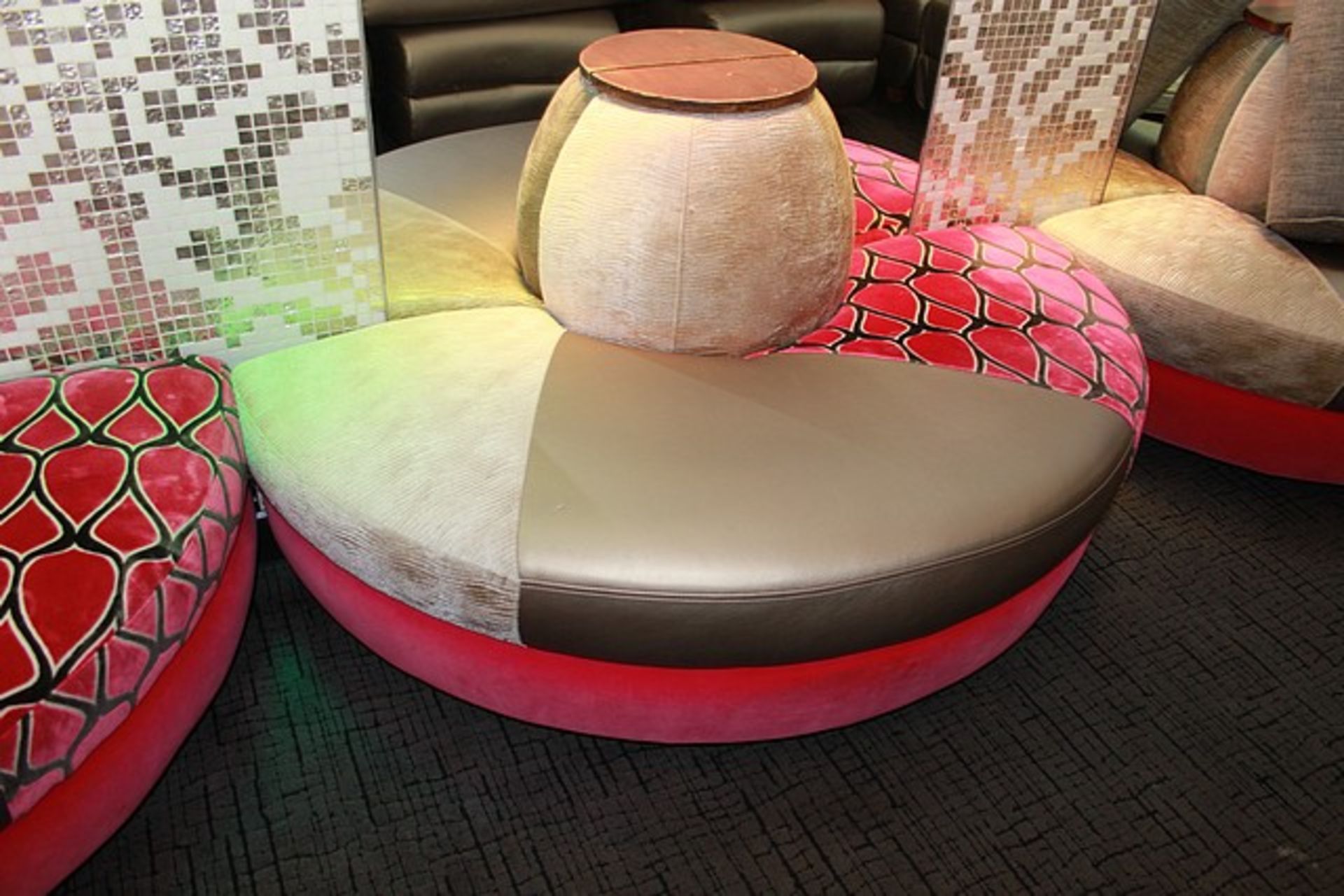 Banquet seating upholstered in pink curved sectional with large backrest section 700mm seat pitch