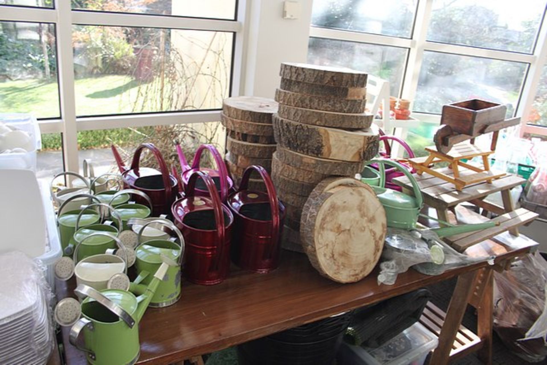 A large quantity decorative garden objet art comprising of watering cans, wooden wheelbarrows, - Image 4 of 4