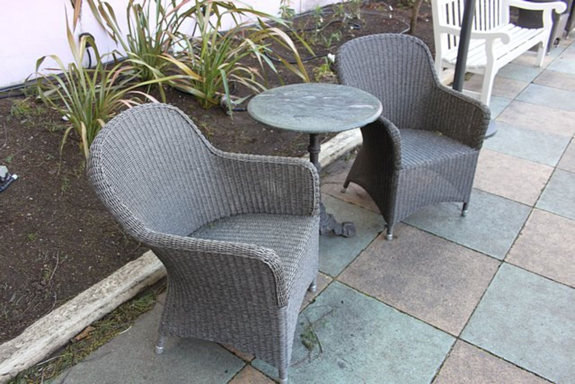 Monte Carlo rattan armchairs complete with a marble top solid cast ornate base table 600mm