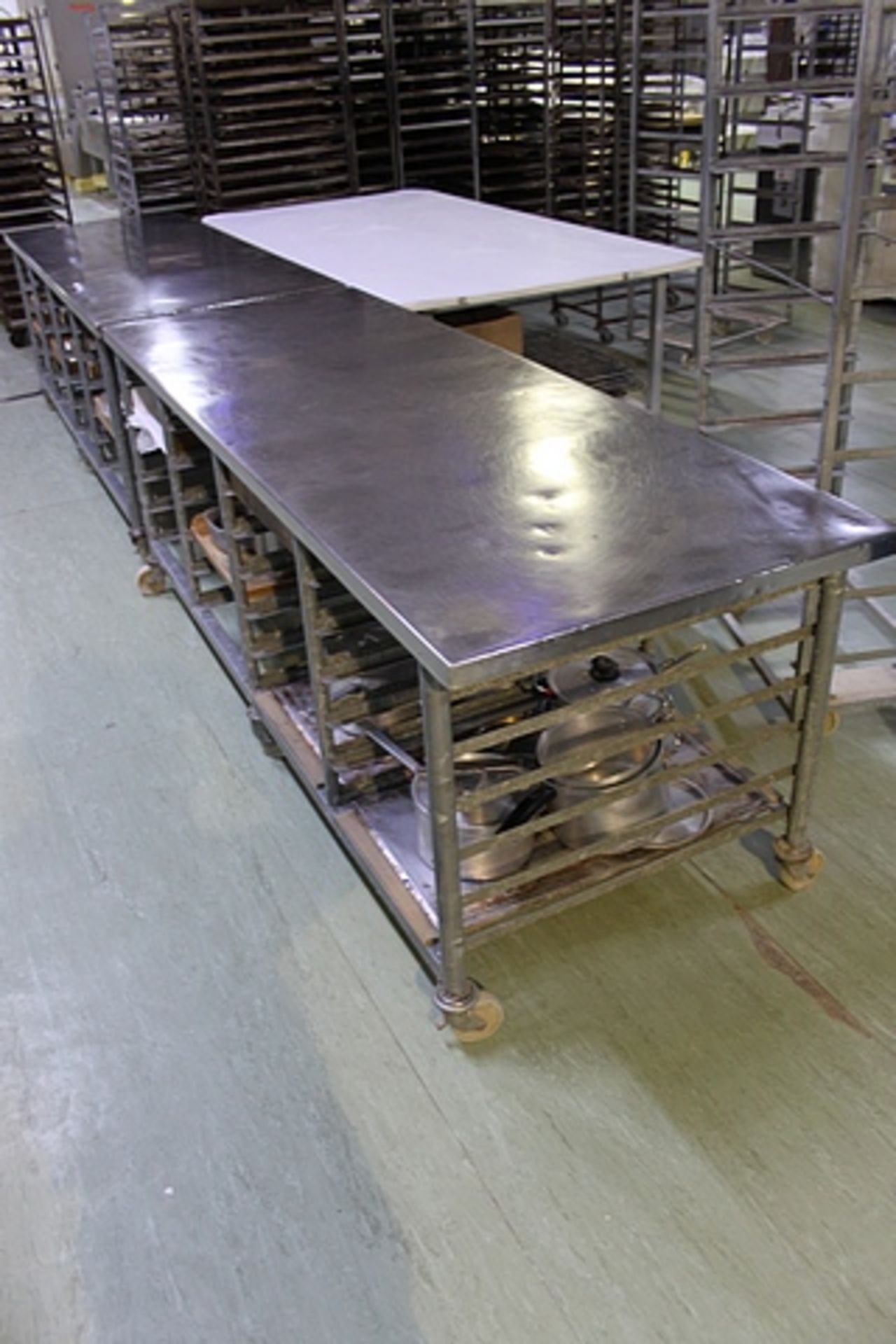 Stainless steel table with 24 tray storage under 2350mm x 840mm