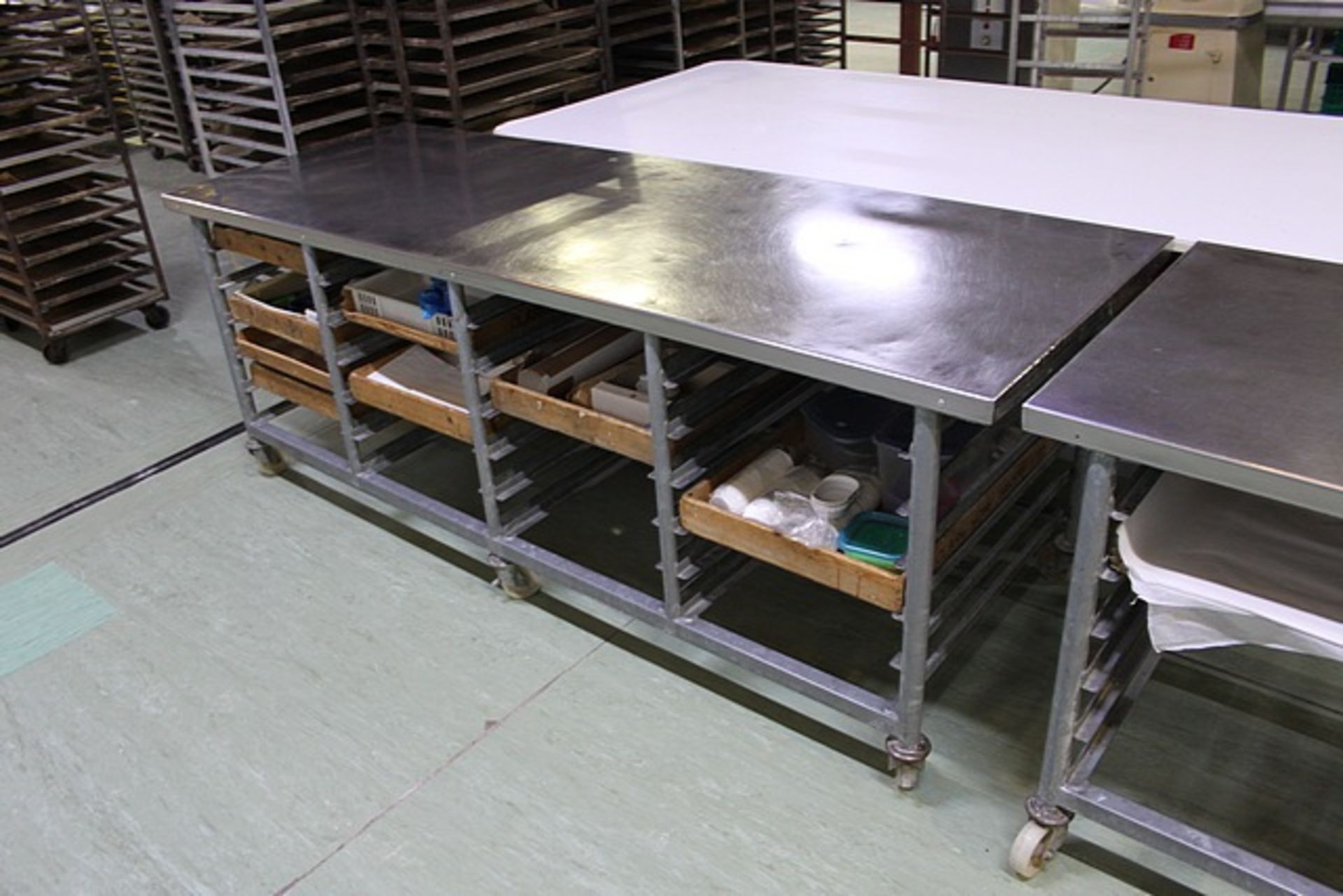 Stainless steel table with 24 tray storage under 2350mm x 840mm