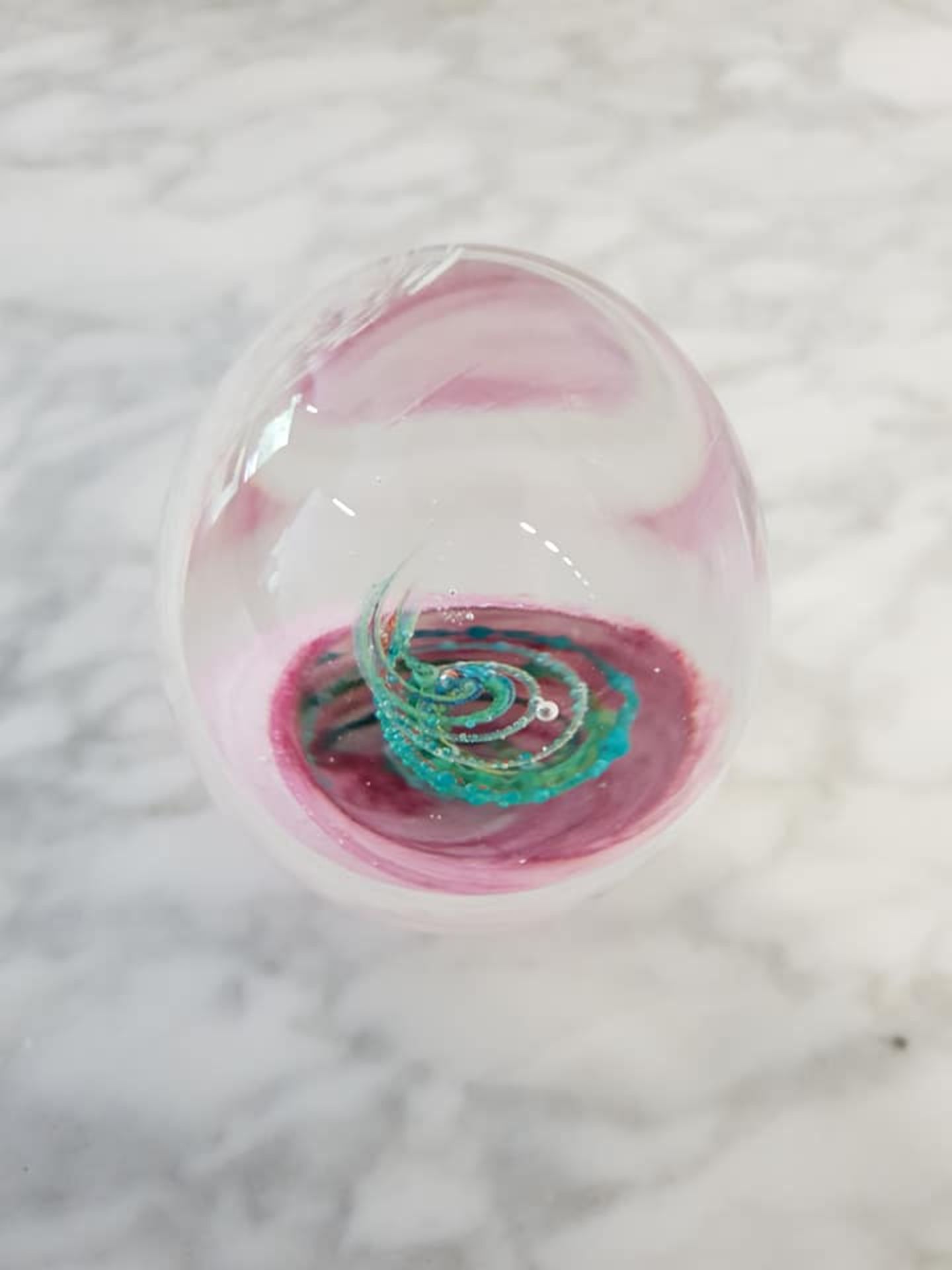 Bohemian blown art glass ovoid paperweight 10cm pink and white with a green floral design