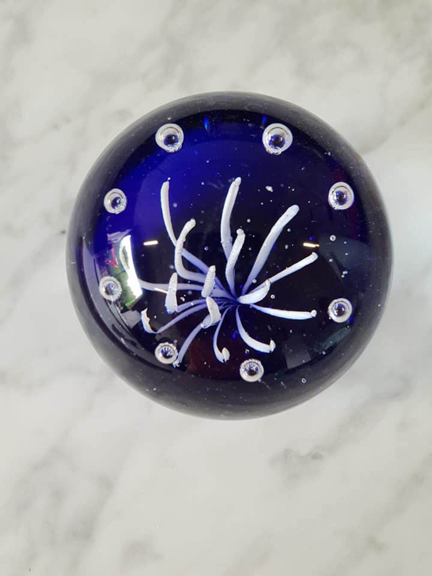 Bohemian blown art glass sphere paperweight 8cm navy blue middle with white floral pattern and