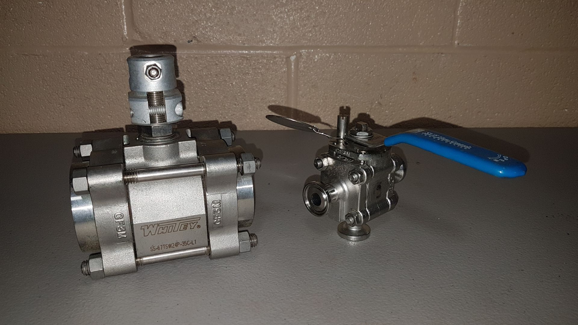 Lot of (2) stainless steel ball valves, 1.25" Whitey ball valve, and 0.5" SVT 3-way ball valve.