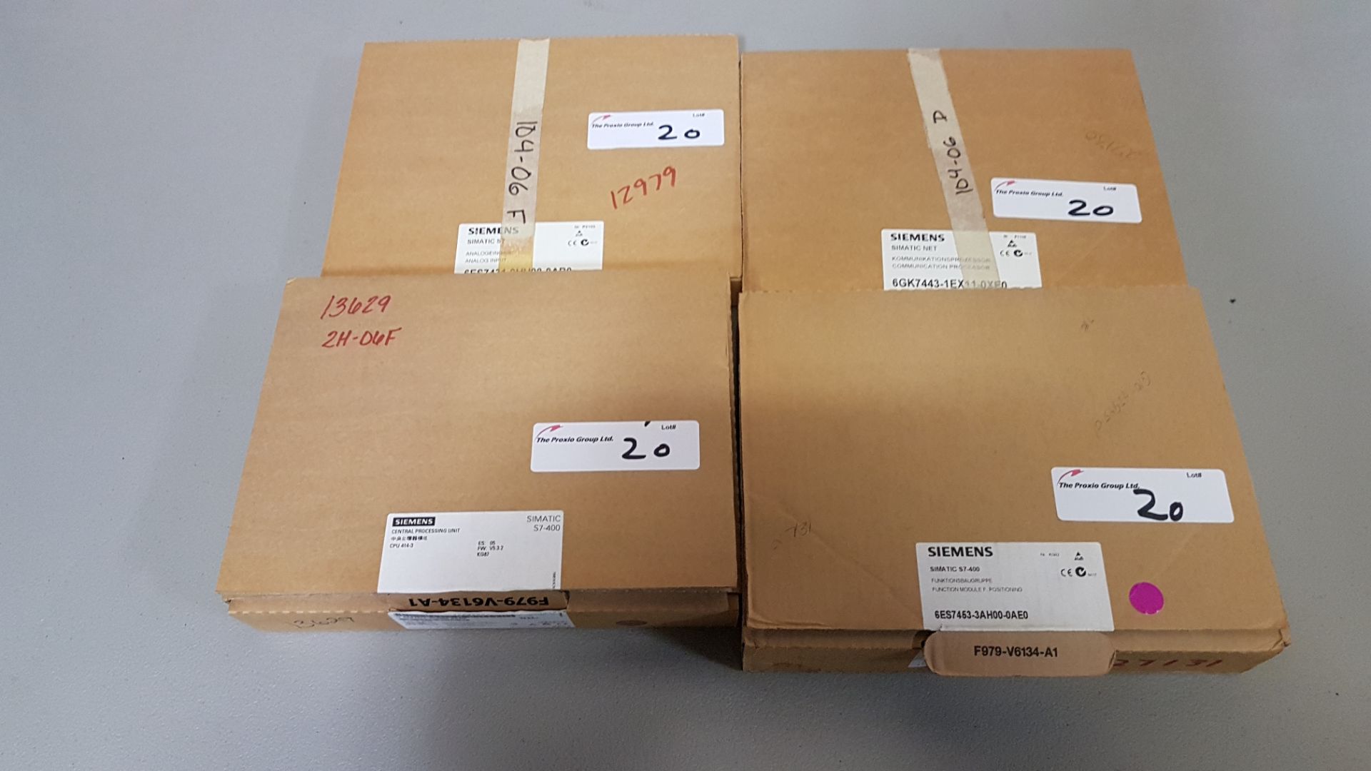 Siemens PLC components, unused in boxes.