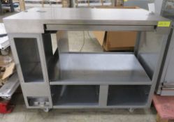 Stainless steel serving unit with under counter storage mounted on wheels