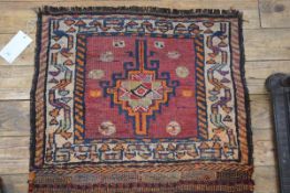 A Caucasian mat, with central leaf medallion enclosed within a lozenge and leaf border, terracotta