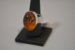 A Continental silver and amber (untested) dress ring, with large oval cabochon, stamped 925.